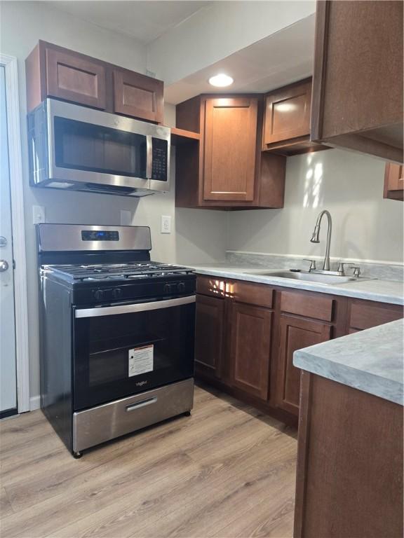 kitchen featuring light hardwood / wood-style floors, sink, and stainless steel appliances