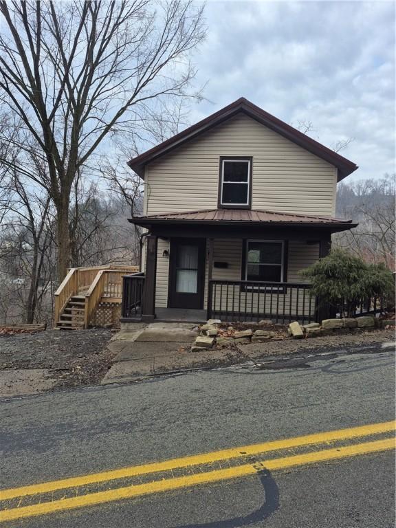 view of front of house with covered porch and metal roof