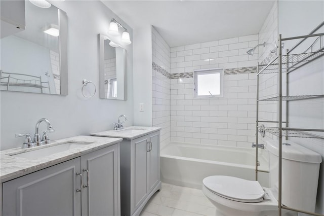 full bathroom with toilet, vanity, and tiled shower / bath combo