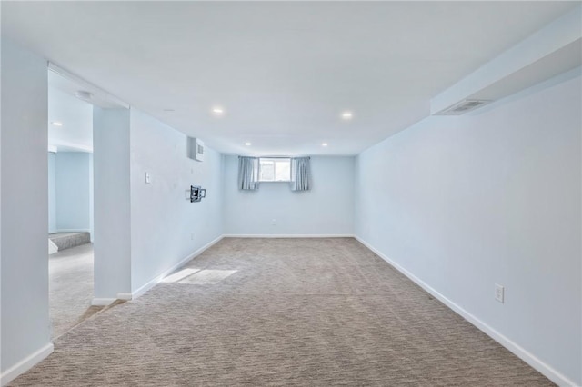 basement featuring light colored carpet