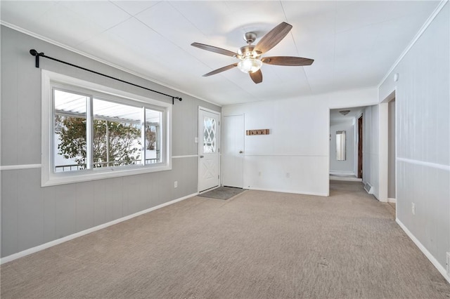 carpeted spare room with ceiling fan