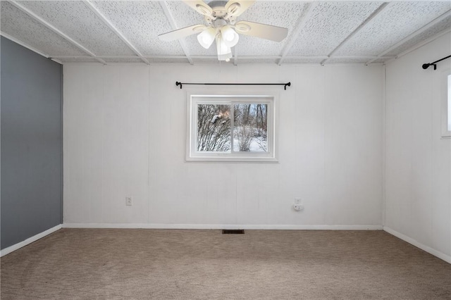 carpeted spare room with ceiling fan