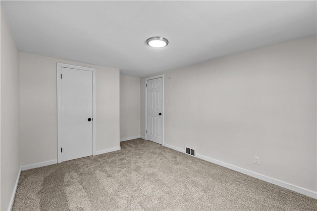 unfurnished room with light carpet