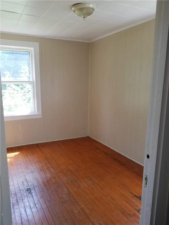 unfurnished room with wood-type flooring