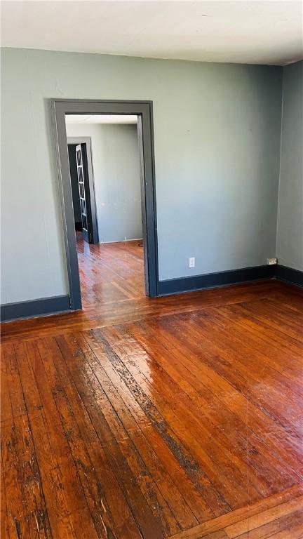 empty room with hardwood / wood-style floors