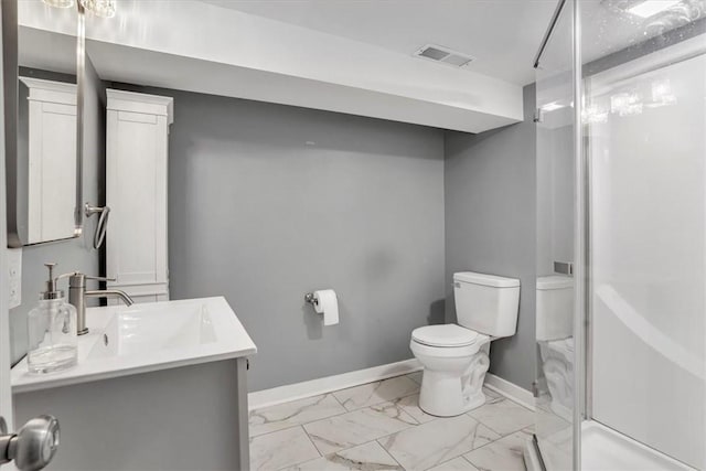 bathroom featuring a shower with door, toilet, and vanity