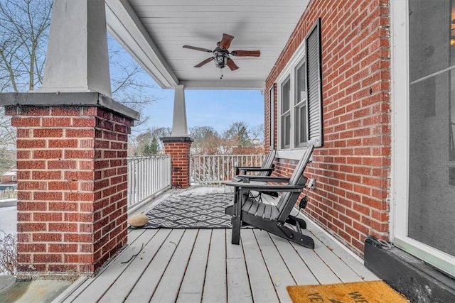 wooden terrace with ceiling fan and a porch