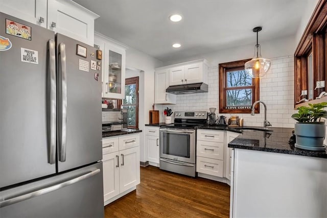 kitchen with appliances with stainless steel finishes, decorative backsplash, white cabinets, and sink