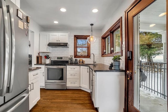 kitchen with decorative light fixtures, white cabinets, sink, and stainless steel appliances