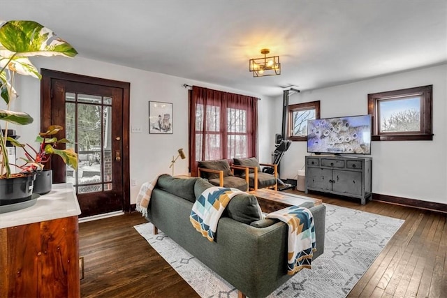 living room with plenty of natural light and dark hardwood / wood-style flooring