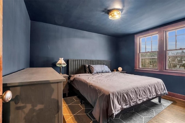 bedroom with dark hardwood / wood-style flooring