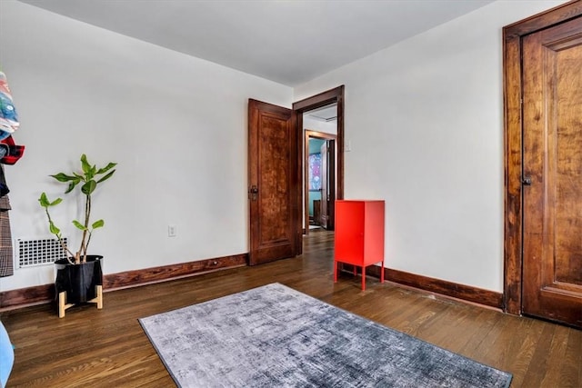 sitting room featuring dark wood-type flooring