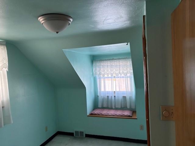 bonus room featuring lofted ceiling