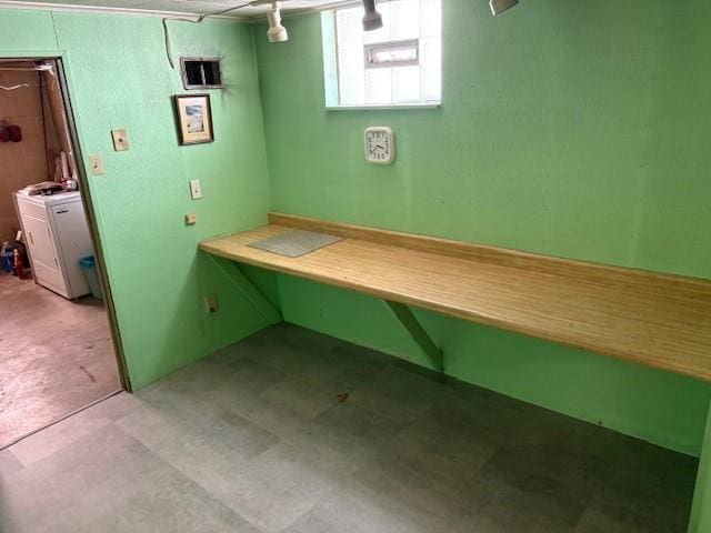 basement featuring light colored carpet and washer / dryer