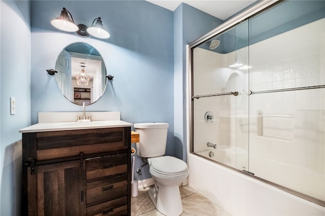 full bathroom featuring combined bath / shower with glass door, vanity, toilet, and tile patterned flooring