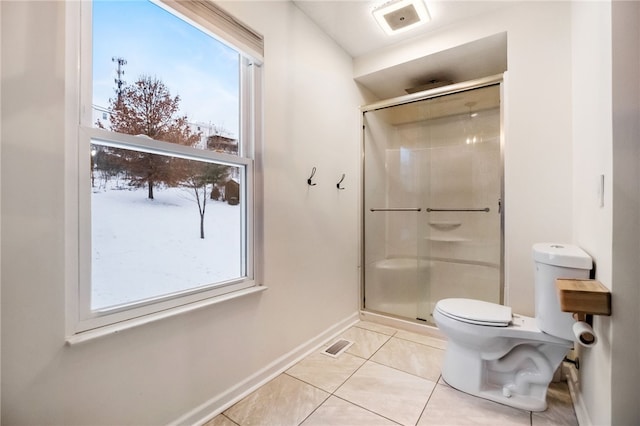 bathroom featuring toilet, walk in shower, and tile patterned flooring