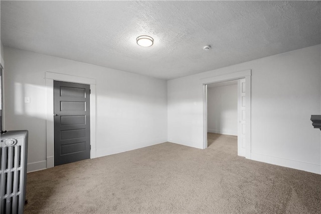 spare room with carpet floors and a textured ceiling