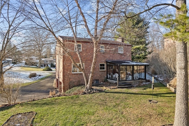 back of property with a porch and a lawn