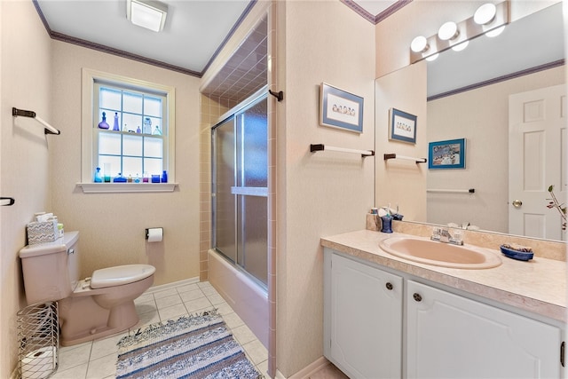 full bathroom featuring toilet, combined bath / shower with glass door, tile patterned floors, crown molding, and vanity