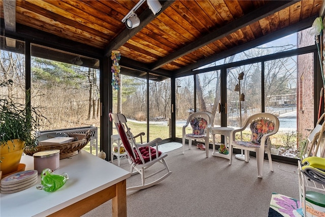 unfurnished sunroom with wooden ceiling and lofted ceiling with beams