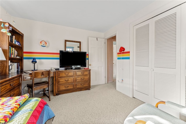 bedroom with light colored carpet and a closet