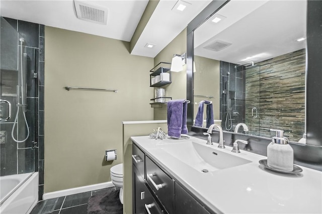 full bathroom featuring toilet, vanity, tile patterned flooring, and shower / bath combination with glass door