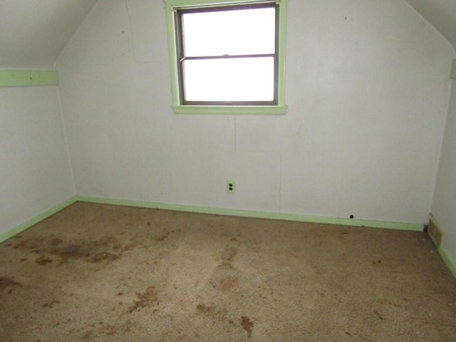 bonus room featuring carpet flooring and vaulted ceiling