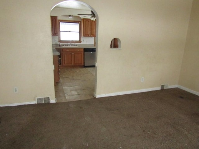 interior space featuring sink, dishwasher, and light carpet