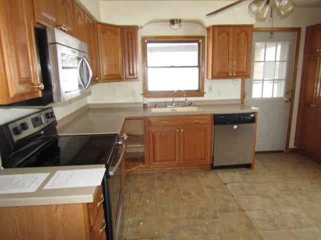 kitchen featuring ceiling fan, appliances with stainless steel finishes, and sink