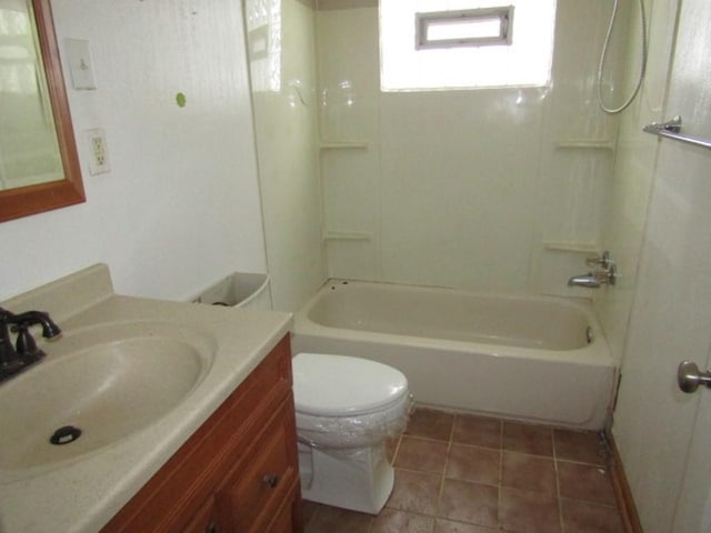 full bathroom with washtub / shower combination, toilet, vanity, and tile patterned flooring