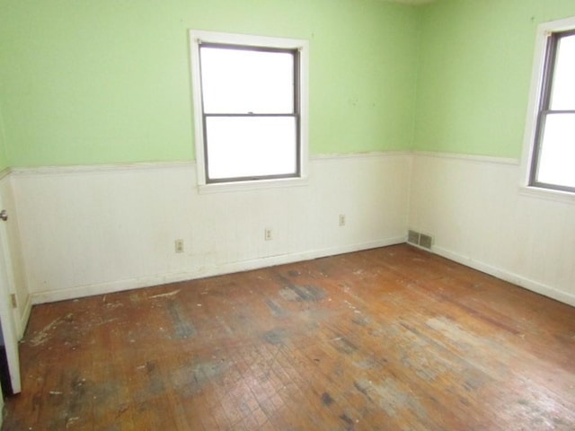 unfurnished room with hardwood / wood-style flooring