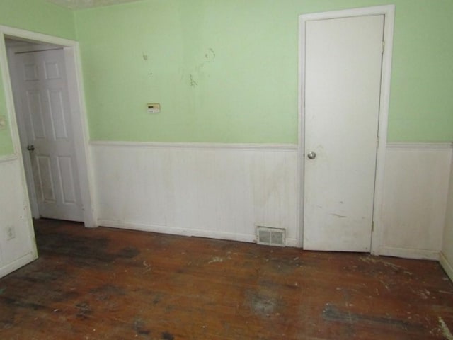 spare room with wood walls