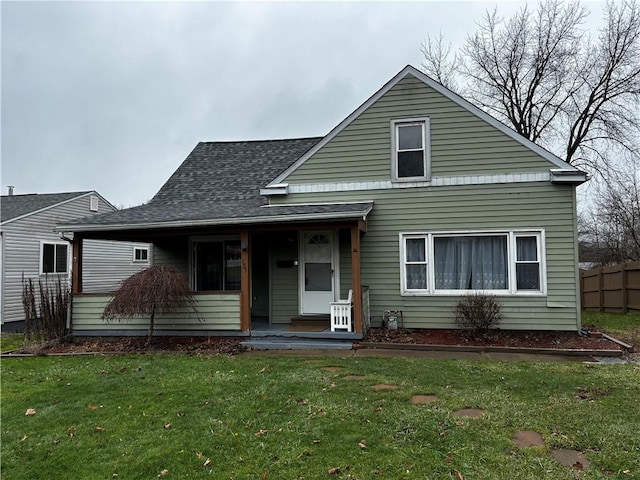 view of front of home with covered porch and a front yard