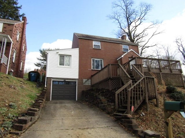 view of front facade with a garage and a wooden deck