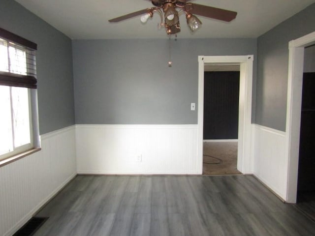 unfurnished room with ceiling fan and hardwood / wood-style flooring