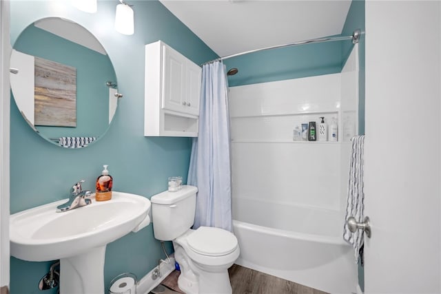 full bathroom featuring toilet, sink, shower / bath combo with shower curtain, and hardwood / wood-style flooring