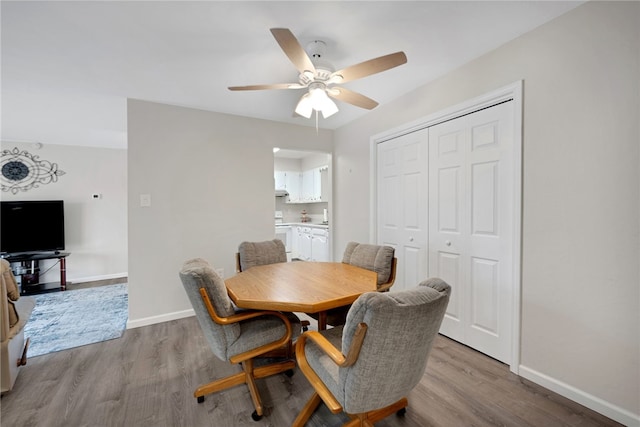 dining room with light hardwood / wood-style floors and ceiling fan