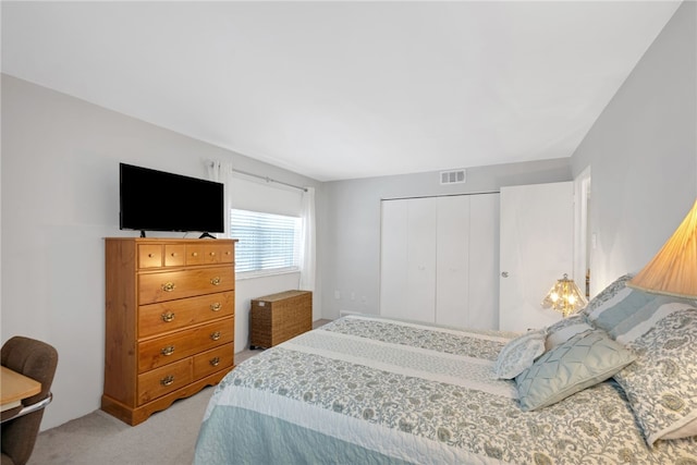 bedroom with light colored carpet and a closet