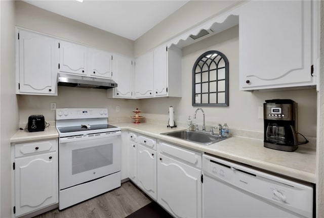 kitchen with white cabinets, sink, white appliances, and light hardwood / wood-style flooring