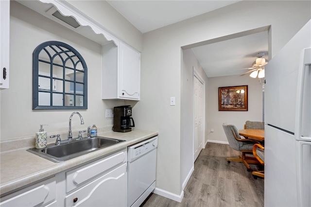 kitchen featuring ceiling fan, light hardwood / wood-style floors, sink, white appliances, and white cabinetry