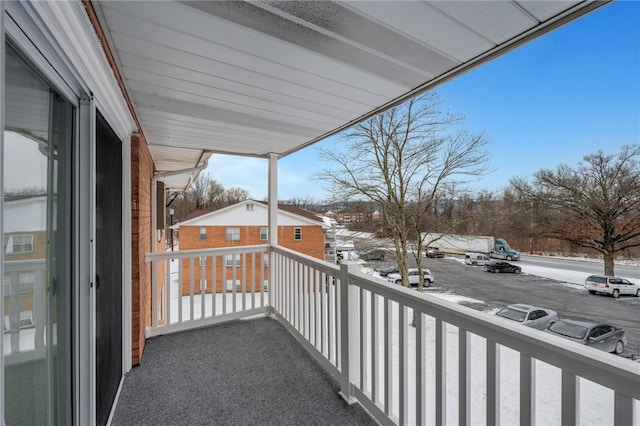 view of snow covered back of property