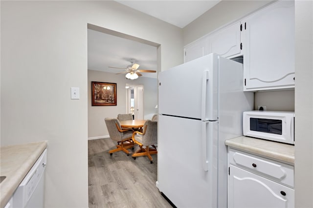 kitchen featuring ceiling fan, white appliances, white cabinets, and light wood-type flooring