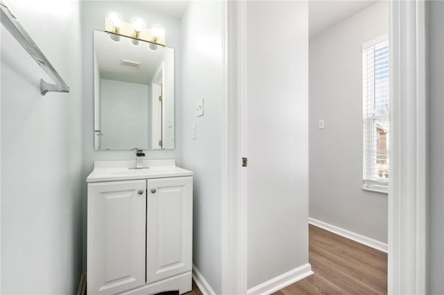 bathroom with hardwood / wood-style flooring and vanity