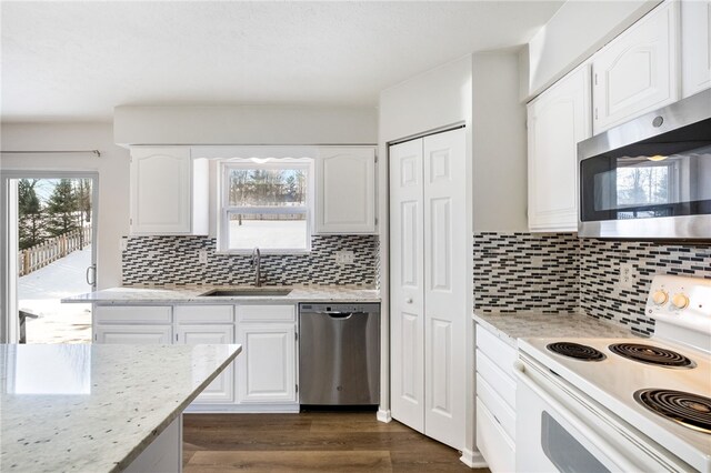 kitchen featuring appliances with stainless steel finishes, sink, and white cabinets