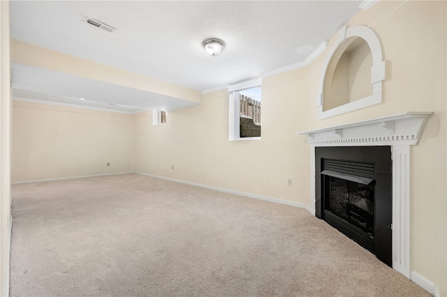 basement featuring ornamental molding and light carpet