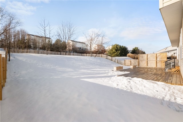 snowy yard with a deck