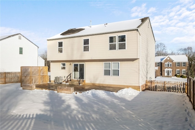 snow covered property with cooling unit