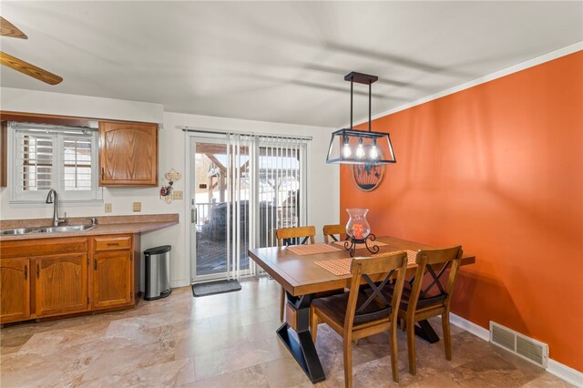 dining area featuring sink and a wealth of natural light