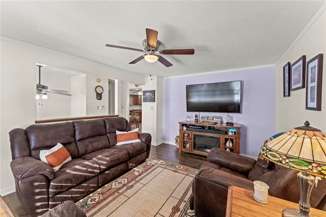 living room featuring ornamental molding, dark hardwood / wood-style floors, and ceiling fan