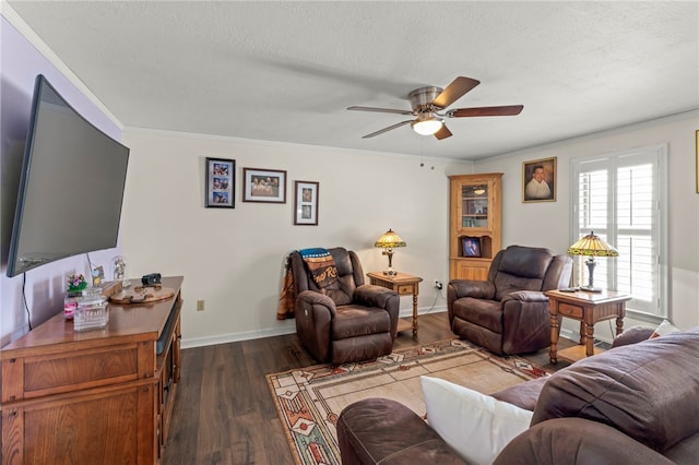 living room with ceiling fan, crown molding, dark wood-type flooring, and a textured ceiling